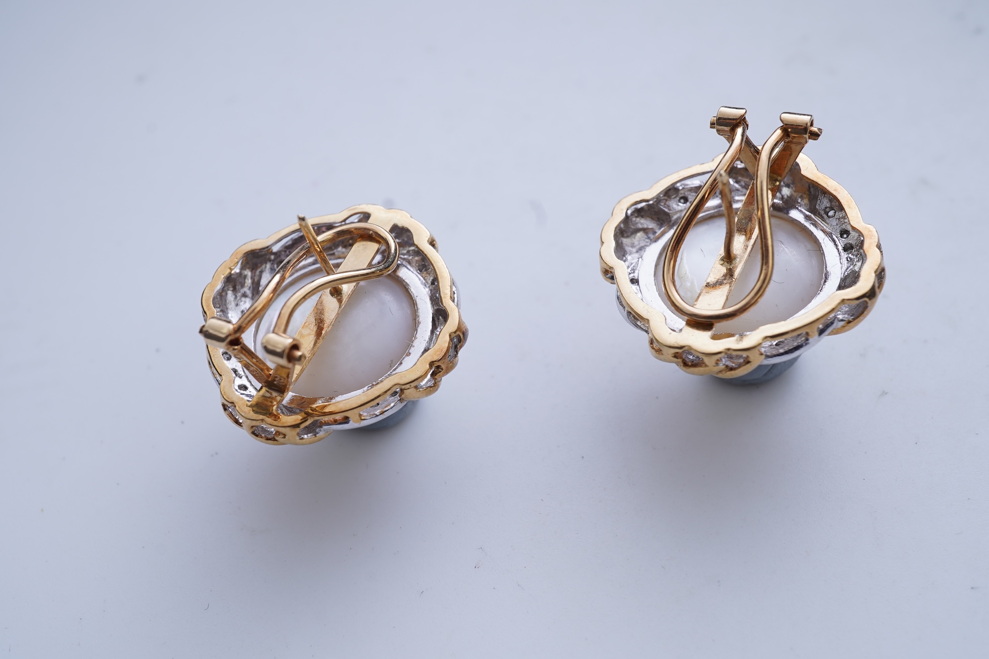 A pair of mabé cultured pearl and diamond earrings